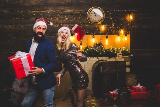 Portrait of a young beautiful smiling couple in home Christmas mood. Love. Positive human emotions facial expressions. Active couples celebrate Christmas. Sensual girl for Christmas