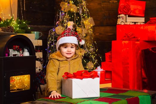 Happy smiling child with new year gift. Merry Christmas and Happy Holiday. Girl kid santa hat with present counting time to new year