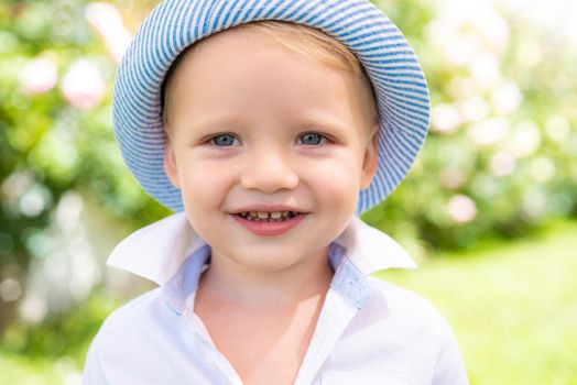 Portrait of happy smiling child boy on nature background. Only fun is on my mind