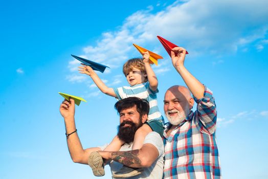 Men generation: grandfather father and grandson are hugging looking at camera and smiling. Child happy. Fathers day concept