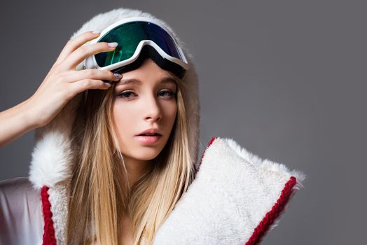 Sexy woman in winter clothes. Portrait of cool young girl in protective helmet and ski mask. Winter time. Attractive athletic woman in ski mask. Leisure. Winter sport. Girl in ski mask. Snowboarding