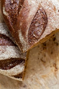 Black gray bread on a board . photo close-up of a piece of a loaf with a shallow depth of field