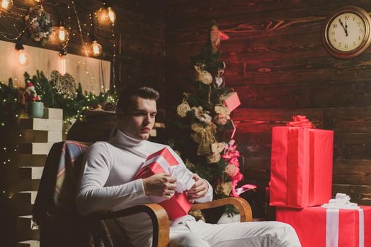 Man handsome with gift box surprise waiting midnight. Gift card concept. Christmas eve. Home. Holiday. Happy christmas. Celebrating Christmas together. Christmas celebration traditions