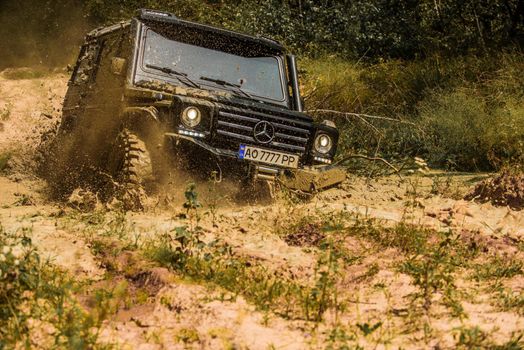 Off road. 4x4 travel trekking. Motion the wheels tires and off-road. Travel concept with big 4x4 car. Rally racing. Mudding is off-roading through an area of wet mud or clay. Jeep outdoors adventures