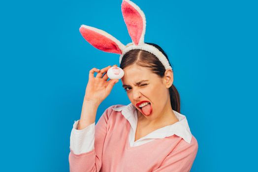 Happy easter. Young woman in rabbit bunny ears. Portrait of a happy woman in bunny ears. Egg hunt. Lips and Easter, Lipstick kiss imprint on easter egg