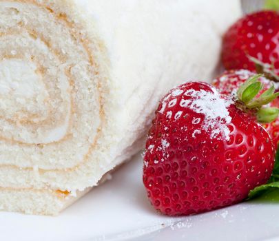 roll with cottage cheese and red strawberries. close-up photo