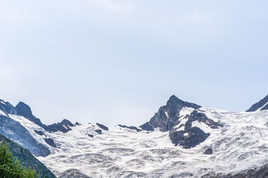 The rocky mountains were shrouded in clouds on a Sunny day.