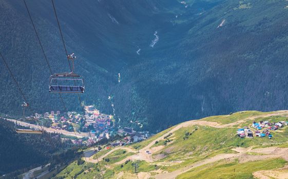 Cableway on mountaintop with benches.