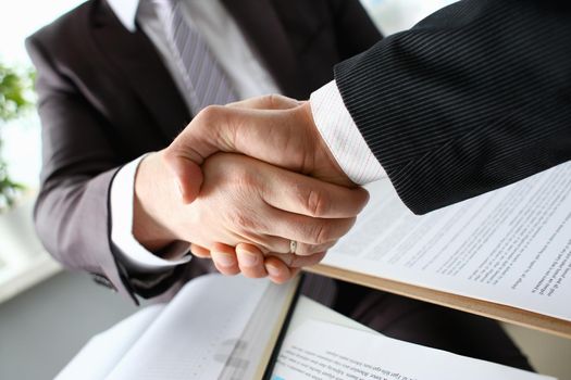 Man in suit shake hand as hello in office closeup. Friend welcome mediation offer positive introduction greet or thanks gesture summit participate approval motivation strike arm bargain concept