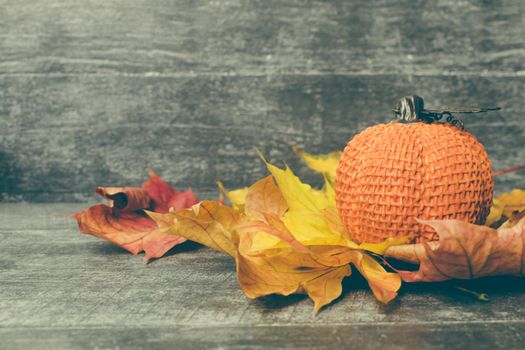 Autumn composition. Pumpkin, dried leaves on pastel gray wooden background. Autumn, fall, halloween concept. Flat lay, top view, copy space