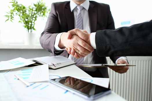 Man in suit shake hand as hello in office closeup. Friend welcome mediation offer positive introduction greet or thanks gesture summit participate approval motivation strike arm bargain concept