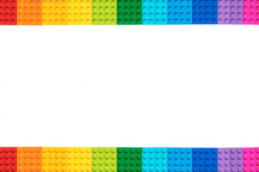 Multicolor lego constructor bricks on white background. Popular toys. Copyspace