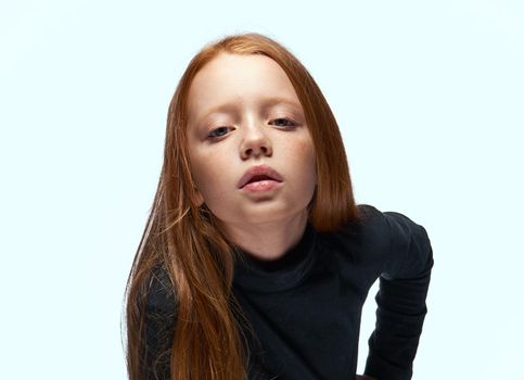 red-haired girl in a black sweater planning close-up. High quality photo