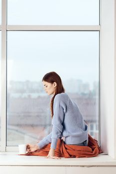 woman near the window dreamy look rest at home comfort. High quality photo