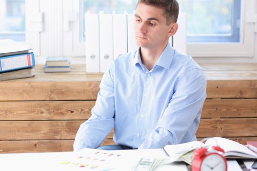 Businessman in blue shirt is bored and sad at office portrait