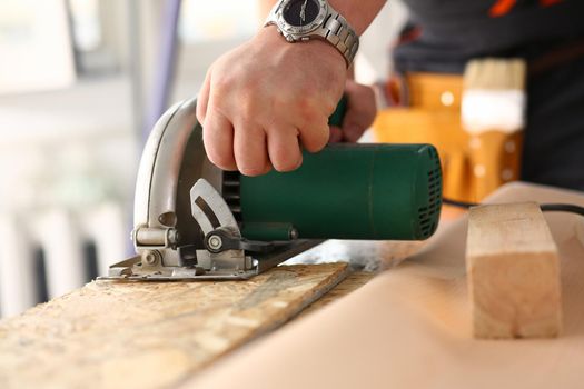 Arms of worker using electric saw closeup. Manual job workplace DIY inspiration improvement fix shop yellow helmet hard hat joinery startup idea industrial education profession career concept