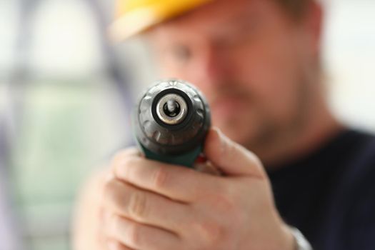 Arms of worker using electric drill closeup. Manual job DIY inspiration improvement job fix shop yellow helmet joinery startup idea industrial education profession career concept