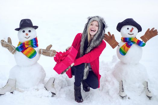 Winter woman. Winter portrait. Winter woman clothes. Making snowman and winter fun for people
