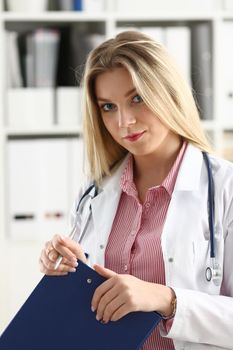 Female medicine doctor hand hold jar of pills and write prescription to patient at worktable. Panacea and life save, prescribing treatment, legal drug store concept. Empty form ready to be used