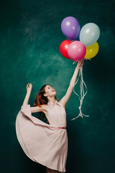 cheerful woman with colorful balloons birthday fun. High quality photo