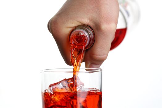 Male hand pours from bottle drink for a cocktail in glass beaker background