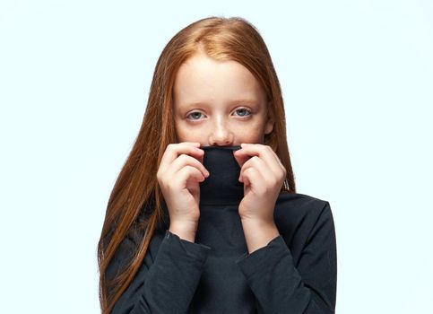 red-haired girl in a black sweater planning close-up. High quality photo