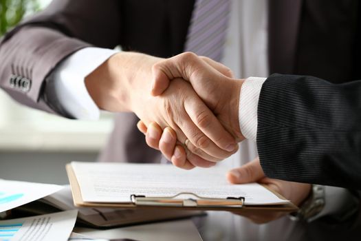 Man in suit shake hand as hello in office closeup. Friend welcome mediation offer positive introduction greet or thanks gesture summit participate approval motivation strike arm bargain concept