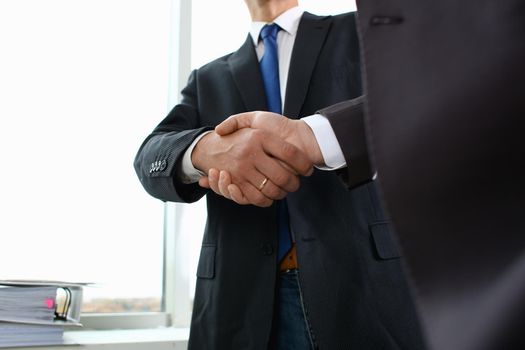 Man in suit shake hand as hello in office closeup. Friend welcome mediation offer positive introduction greet or thanks gesture summit participate approval motivation strike arm bargain concept