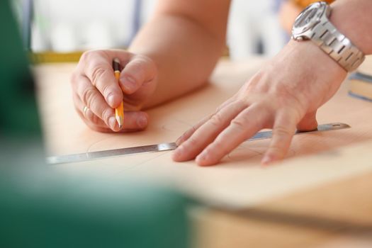 Arms of worker making structure plan on scaled paper closeup. Manual job DIY inspiration improvement job fix shop graphic joinery startup workplace idea designer career industrial education