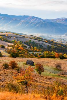 Colorful autumn landscape in the mountain village. Foggy morning in the Carpathian mountains. Pishkonia, Ukraine, Europe.
