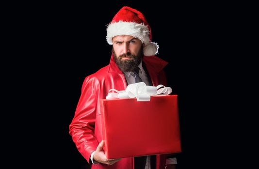 Bearded modern santa on black background wishes Merry christmas and Happy new year. Christmas gift