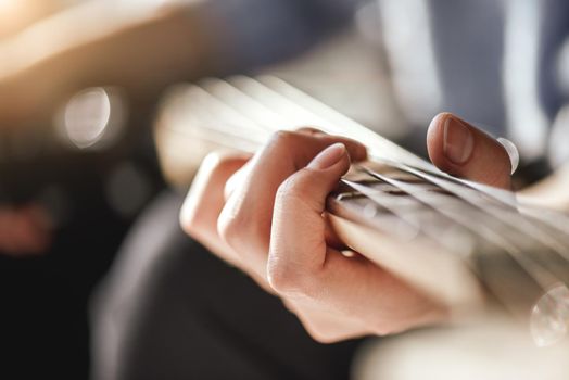 Guitar lessons. Close-up photo of male playing guitar. Creativity. Music lessons