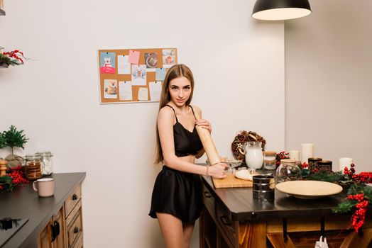 A portrait of smiling young housewife in a modern kitchen