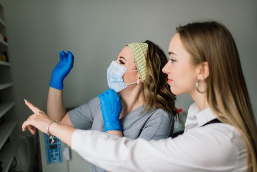 Female manicure master in beauty salon work with hands of the client