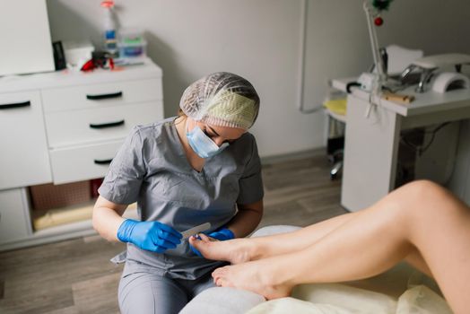 Photo of the professional pedicure process with model