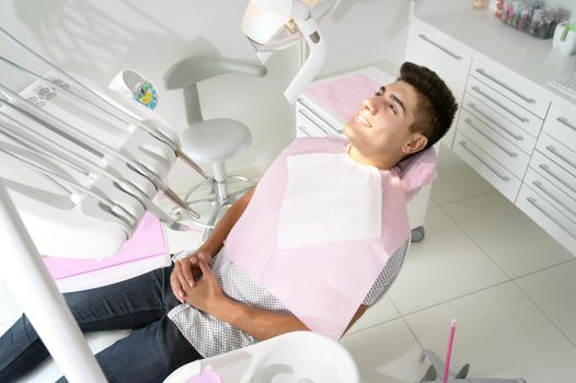 Young Patient in modern dental clinic. High quality photo