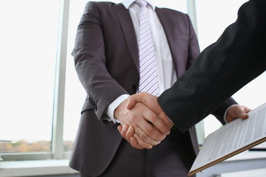 Man in suit shake hand as hello in office closeup. Friend welcome mediation offer positive introduction greet or thanks gesture summit participate approval motivation strike arm bargain concept