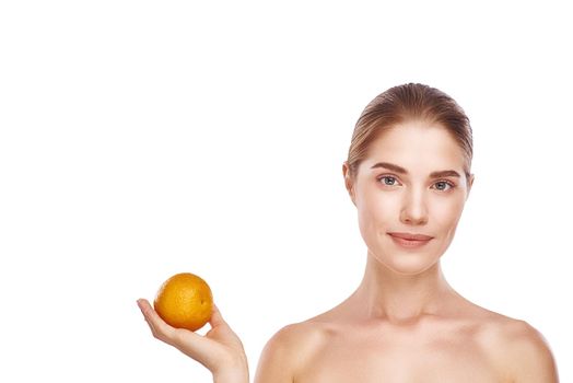 Beautiful womans face with orange close up studio photo on white background. Light hair, grey eyes