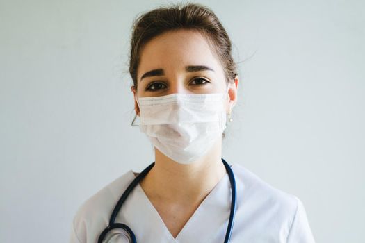 Doctor is a girl in a protective mask on her face. International Doctor's Day.