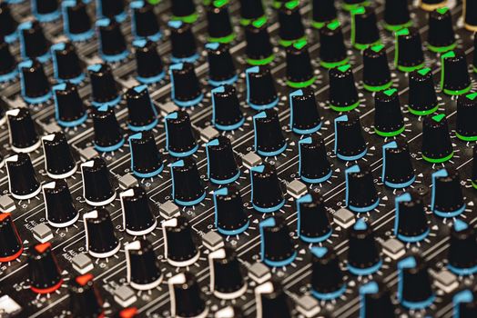 Professional Sound Mixer. Close-up view of colorful control buttons for sound adjusting in a recording studio. Sound equipment. Music record service