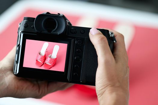 Women's summer high heel shoes on the camera screen, close-up. Photo of shoes, sale in the second hand online store