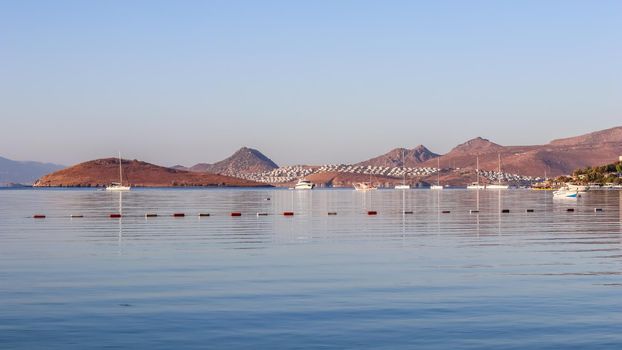 Beautiful sunrise on the Aegean Sea with islands, mountains and boats. High quality photo