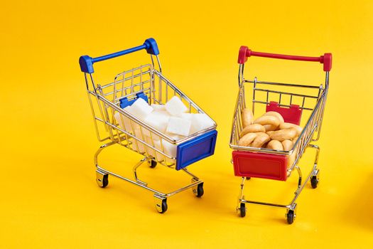 carts with groceries shopping supermarket store yellow background. High quality photo