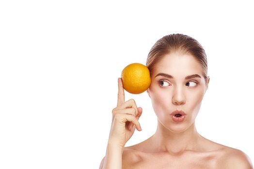 Beautiful womans face with orange close up studio photo on white background. Light hair, grey eyes