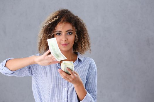 Beautiful black woman portrait. Scattering money notes dollars in fashion vows style curly hair with white locks eye view of the camera