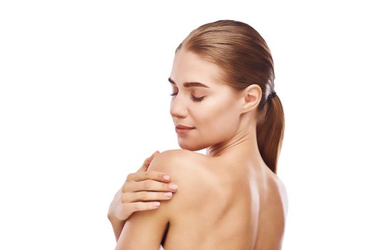 Beautiful womans back close up studio photo on white background. Light hair, grey eyes, closed eyes