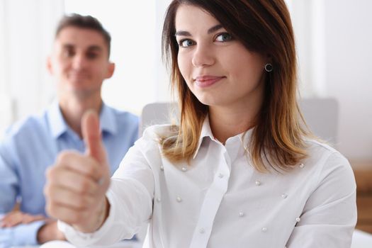 Female hand showing ok or approval sign with thumb up in creative people office during conference. High level and quality service job offer excellent education advisor serious business concept okay