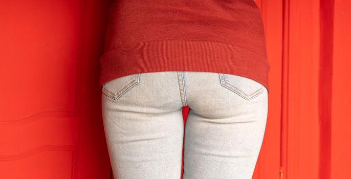 Close up of female buttocks in jeans. Rear view on buttocks of unrecognizable woman
