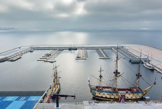 Russia, St. Petersburg, 14 October 2021: Aerial view of the new port Hercules with a replica of the old military frigate Poltava, the port next to the Lakhta center skyscraper. High quality photo