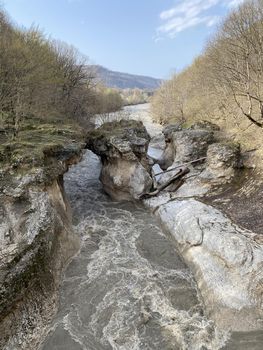 Beautiful landscape of mountain river in amazing and mysterious nature. Mountain waterway flowing through mountainous terrain